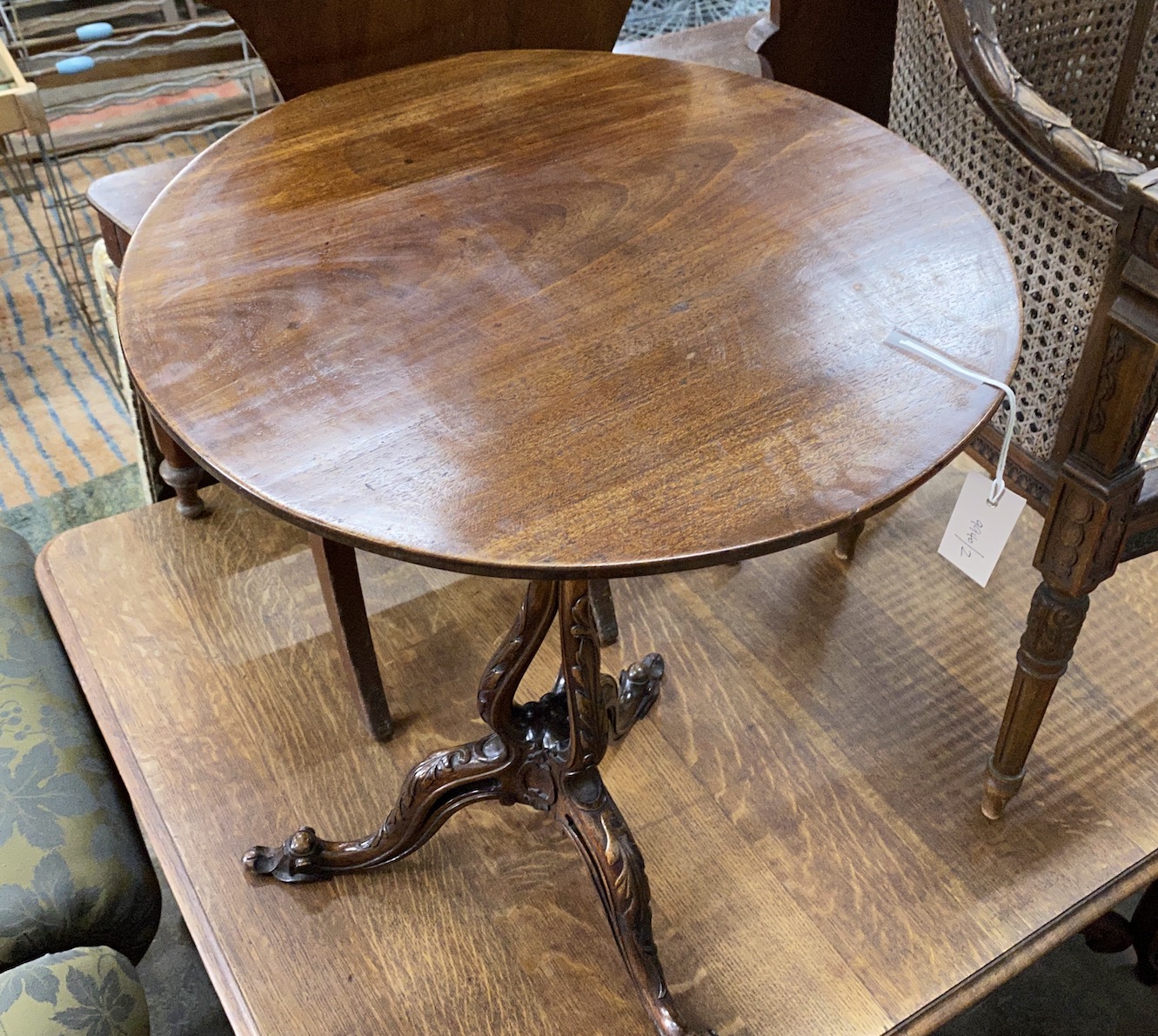 A George III and later mahogany circular tilt top tripod wine table with associated base, diameter 52cm, height 68cm
